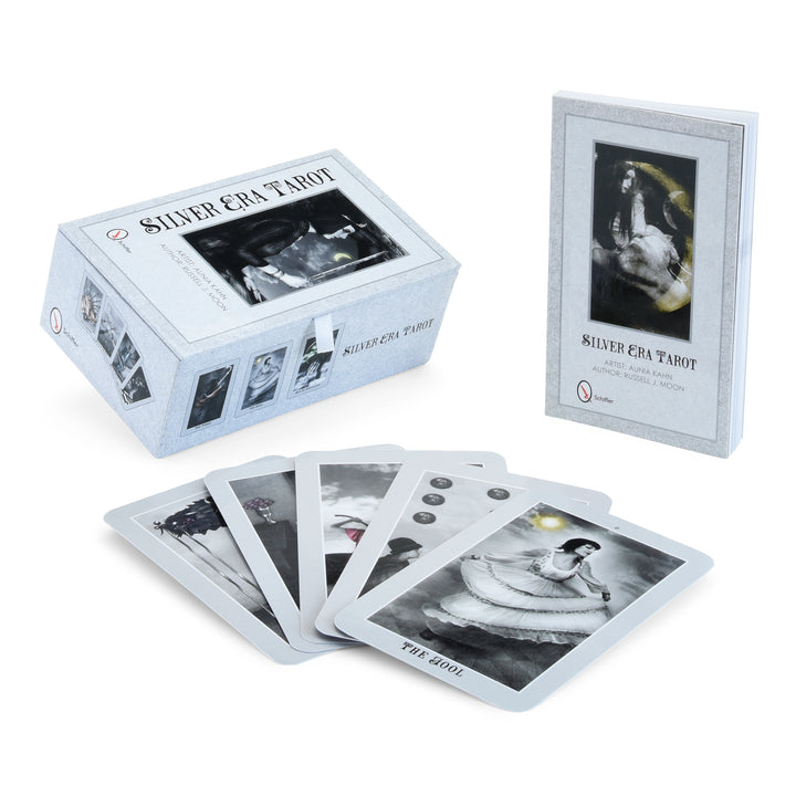The Silver Era Tarot by Schiffer Publishing, Ltd. features artistic black and white cards like The Fool and Four of Pentacles, all elegantly presented with a matching booklet and box.