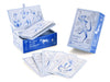The Bleu Cat Tarot by Schiffer Publishing, Ltd. is shown in a light blue box with a stylized cat; whimsical cat tarot cards are spread in front while the deck remains partially inside the open package.