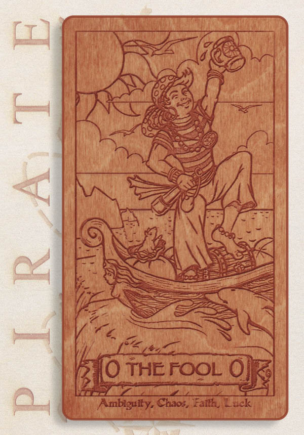 The Pirate Tarot’s engraved wooden Fool card shows a cheerful pirate raising a mug on a ship’s plank. Waves, clouds, a bird, and keywords—Ambiguity, Chaos, Faith, Luck—add to this playful scene from the Pirate Tarot deck.