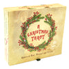 A beige box with red text reading A Christmas Tarot inside a pine and berry wreath. Below, it says Ghosts of Past, Present and Future. This Majors-only deck by Schiffer Publishing, Ltd. has faded images of a child and a shocked person in the background.