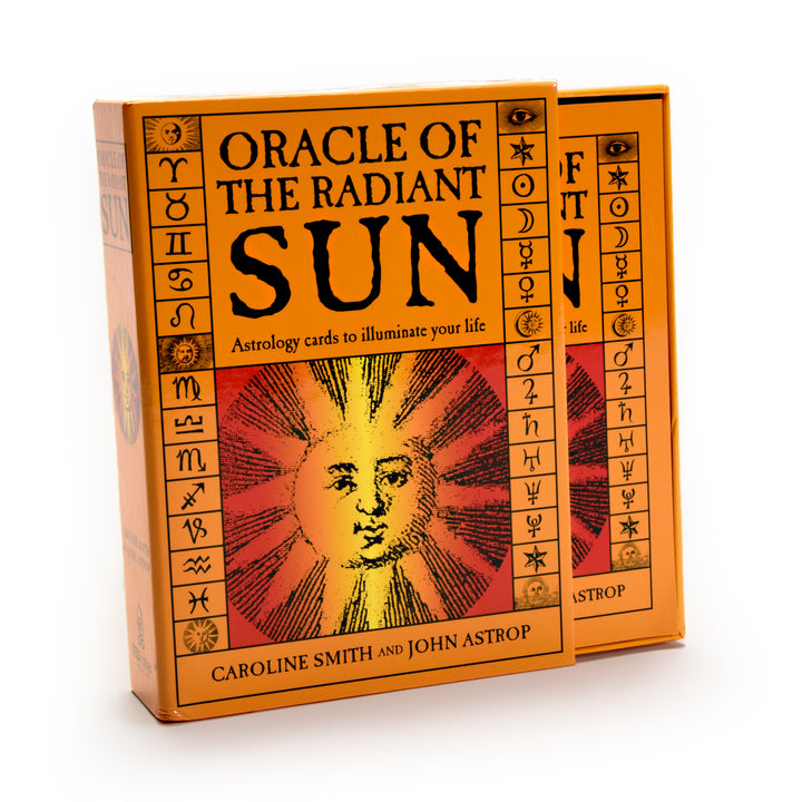 Two orange boxes of the Oracle of the Radiant Sun astrology deck by Schiffer Publishing, Ltd., featuring a stylized sun face and astrological symbols on the cover.
