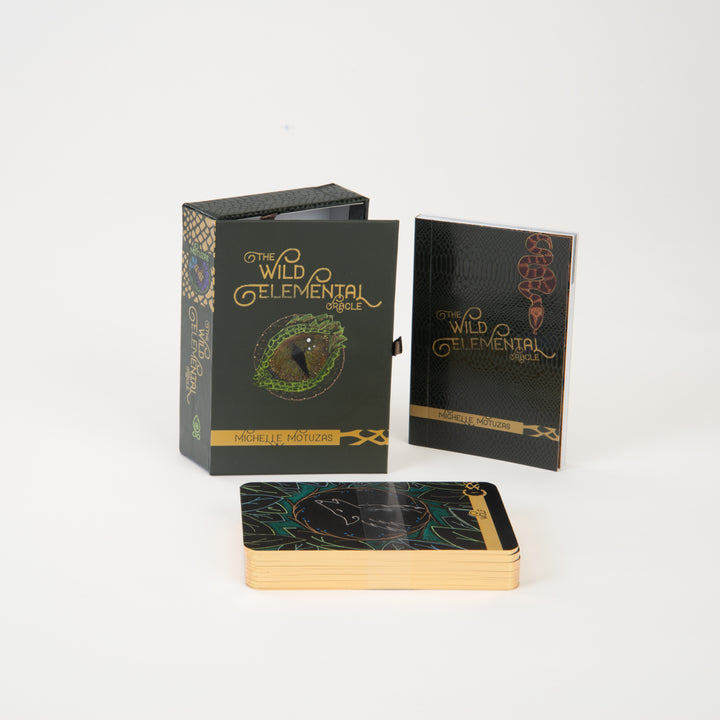 The Wild Elemental Oracle by Schiffer Publishing, Ltd. is a boxed set featuring animal oracle cards with gold edges and vibrant designs, plus a guidebook—all artfully displayed on a white background.