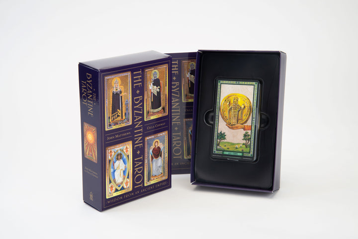 The Byzantine Tarot by Schiffer Publishing, Ltd. is shown: the box on the left features illustrated cards, while the opened box on the right reveals a single card from this unique Byzantine Empire-inspired Tarot deck, set against a plain white background.