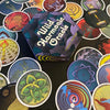 A hexagonal box labeled Wild Harmonic Oracle Cards from Schiffer Publishing, Ltd. is surrounded by vibrant chakra cards with abstract designs, each inspired by energy alchemy and spread out in a colorful fan shape.