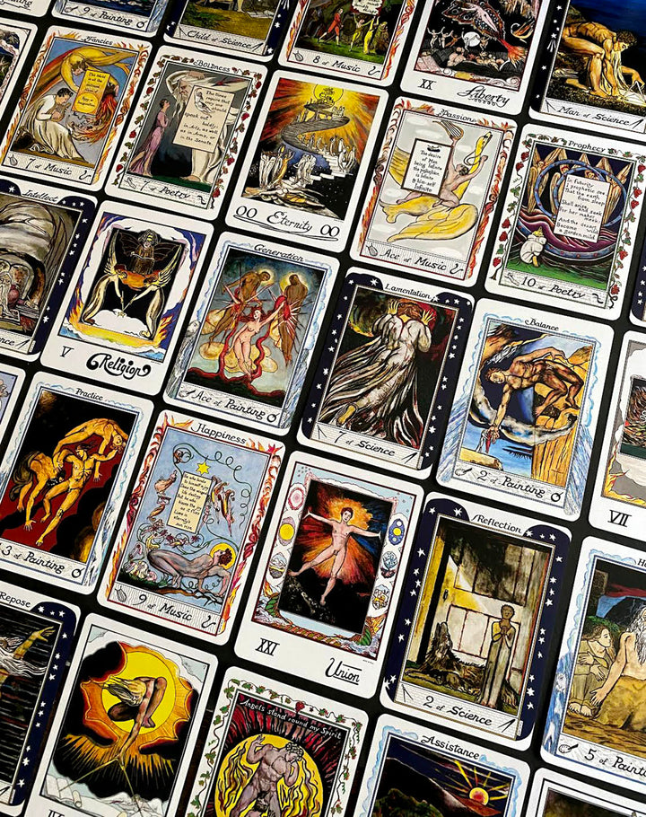 A spread of The William Blake Tarot of the Creative Imagination by Schiffer Publishing, Ltd. displays vivid cards with unique artwork and symbols, inspiring creativity against a dark backdrop.