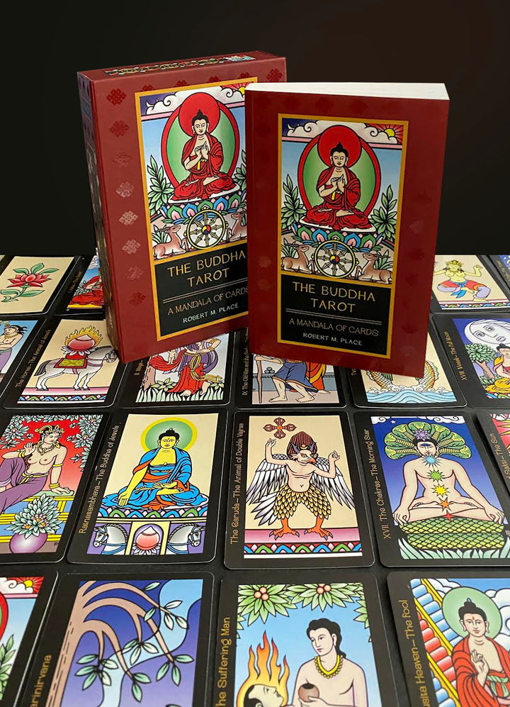 The Buddha Tarot by Schiffer Publishing, Ltd. features vibrant cards with Major Arcana symbolism spread on a surface, while its red box and guidebook with an illustrated Buddha stand upright at the center, evoking enlightenment.