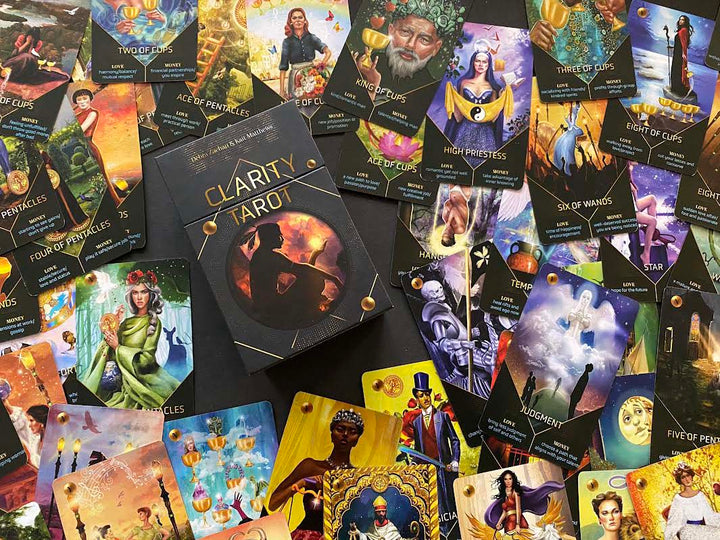 A Clarity Tarot (Deck and Guidebook Box Set) box from Schiffer Publishing, Ltd. is surrounded by vibrant cards from the deck, showcasing cartomancy icons like the High Priestess, Judgment, Cups, Pentacles, and Wands.