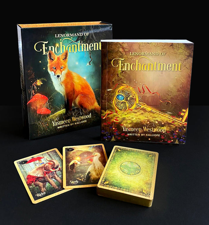 The Lenormand of Enchantment deck set by Schiffer Publishing, Ltd. showcases Yasmeen Westwood’s enchanting illustrations and a fox on the box, with three cards, a guidebook, the deck, and two boxes shown on a black surface.