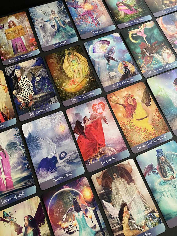 A spread of Angels of Healing and Hope Oracle cards by Schiffer Publishing, Ltd. is laid out, each featuring vibrant fantasy angel art and symbolic imagery with healing titles like “Inner Faith,” “Let Love In,” and “Sensitive Soul.”.