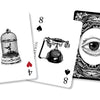 Three playing cards from Inner Eye Oracle by Schiffer Publishing, Ltd. overlap: the 4 of hearts with a birdcage and RESTRICTION, the 8 of spades with a vintage phone and COMMUNICATION, and a card back with an ornate eye.