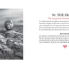 A black-and-white drawing of a boulder sits on rocky ground. On the right, text explains The Erratic card from The Bloodlands Oracle by Schiffer Publishing, Ltd., revealing its meaning and reversed interpretation in this nature-themed deck.
