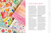 A flat lay displays vibrant fruit, flower, and holiday ornament watercolor paintings beside Modern Watercolor Workshop by Schiffer Publishing, Ltd., featuring beginner-friendly projects and step-by-step painting tips.