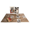 The John Dee Oracle by Schiffer Publishing, Ltd. includes a book, illustrated cards, a brown board with white circles and lines, and a wooden box with a red cover and two gold rings—all displayed on a white background.
