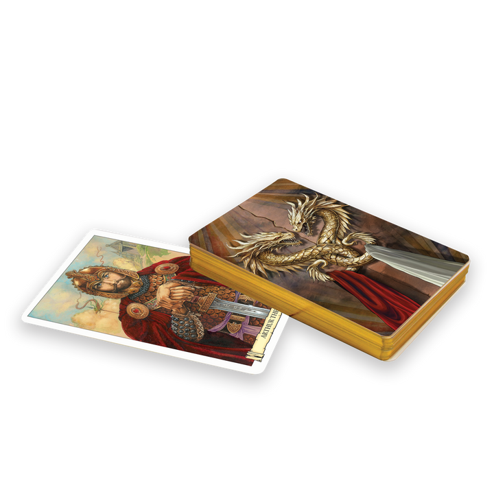The Camelot Oracle by Schiffer Publishing, Ltd. features an Arthurian-inspired tarot deck, partly open to reveal a regal king with a sword and a top card adorned with an ornate golden dragon—ideal for divination and themed readings.