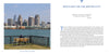 A striking view of Detroit’s skyline—modern and historic skyscrapers under a blue sky, seen from across the river with a grassy foreground—featured in "Detroit" by Schiffer Publishing, Ltd., ideal for Motor City souvenirs or photo books.