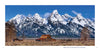 In Grand Teton National Park, a wooden barn and fence sit in an open field before snow-capped peaks under a blue sky. From Schiffer Publishing, Ltd.