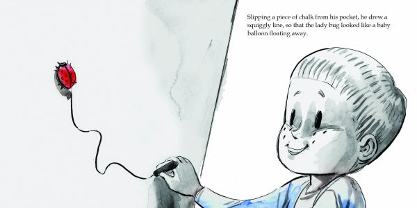 A child with short hair smiles as they draw, bringing Max's Box from Schiffer Publishing, Ltd. to life on the wall—a scene that sparks imagination and joy. Text is displayed in the upper right corner.