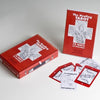 A red box, booklet, and several tarot cards from The Healing Tarot by Schiffer Publishing, Ltd. are shown on a white surface. The cards and booklet display black-and-white medical illustrations for holistic wellness readings.