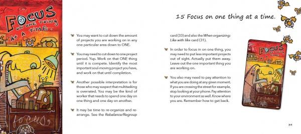 A two-page spread from Manifesting Your Greatness by Schiffer Publishing, Ltd. shows a yellow dog and the phrase "FOCUS on ONE THING at a TIME," with advice below, plus a smaller image from the wisdom cards oracle deck on the right page.