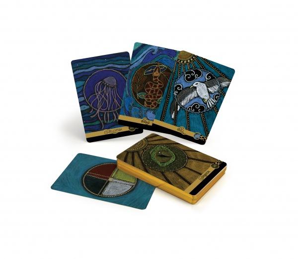 The Wild Elemental Oracle by Schiffer Publishing, Ltd. is shown with vibrant animal cards, including jellyfish and bird designs. Some cards stand upright; others are stacked or face down, ready to share Mother Nature’s wisdom.