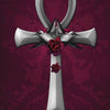 A silver ankh with two hummingbirds and red roses at the center on a dark maroon background evokes oracle card mystique. "Ankh" appears below in elegant script. From The Witch's Oracle, 2nd Edition by Schiffer Publishing, Ltd.