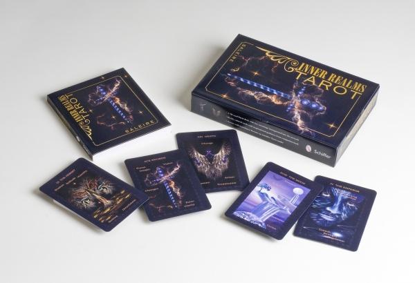 The Inner Realms Tarot by Schiffer Publishing, Ltd. is shown with its box, companion book, and six illustrated cards on a white surface. Its mystical, dark artwork inspires intuitive tarot readings.