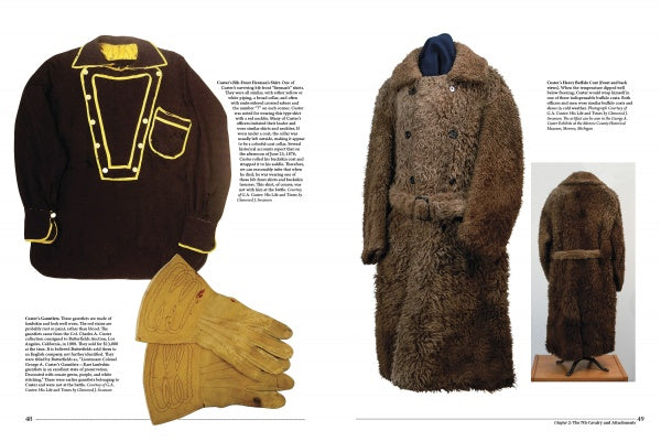 A book spread in "Artifacts of the Battle of Little Big Horn" by Schiffer Publishing, Ltd. showcases a dark shirt with yellow trim, yellow gloves, and a brown fur coat—possible Custer artifacts—displayed with descriptive text blocks.