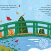 Inspired by Claude Monet's Giverny garden, "A Colorful Tail" by Schiffer Publishing, Ltd. shows a green bridge over a pond—fall leaves on the left, snowy winter on the right, and a fox by the frozen water—ideal for a children's book.