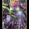 A mystical tarot-style card from the Lenormand Cartomancy deck by Schiffer Publishing, Ltd. features two gray circles with the number 7 and an ethereal woman's face at the center, framed by swirling green and purple floral designs.