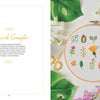 The book "Freshly Stitched" by Schiffer Publishing, Ltd. features a hand-embroidered botanical sampler in a hoop with green leaves, yellow and pink flowers, and gold scissors, perfect for fans of modern embroidery projects. Text reads "Botanical Sampler.
