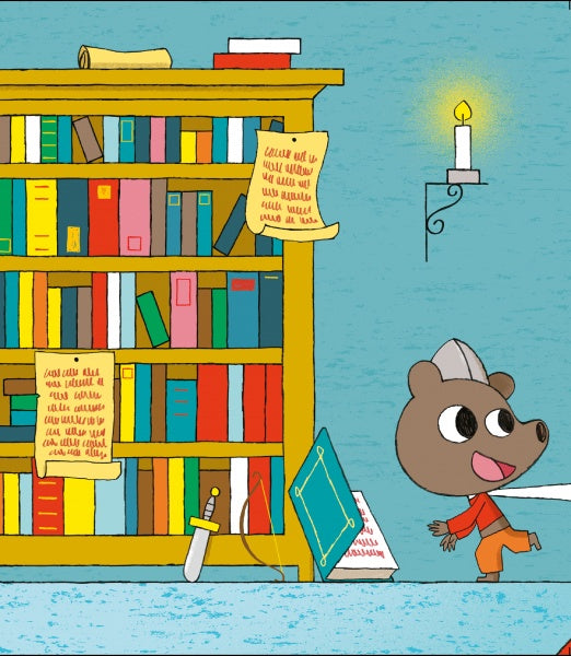 A cheerful bear in a paper hat walks past a bookshelf filled with colorful books and scrolls, including "Dragon's Castle" by Schiffer Publishing, Ltd. A candle glows on the wall, with a toy sword and fallen book on the floor.