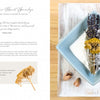 An opened book, "Creating Smudge Sticks" by Schiffer Publishing, Ltd., shows a recipe with a photo of a white bowl of salt and smudge sticks made of sage, lavender, and yarrow—perfect for purification and clearing negative energy.