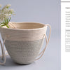 The Artisan Ropework basket by Schiffer Publishing, Ltd. features stitched rope with a subtle zigzag pattern, filled with white flowers on a light surface. A description and materials list for making cotton rope baskets appears on the right.