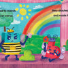 A colorful stage from "Big P Takes a Fall (and That’s Not All)" by Schiffer Publishing, Ltd. shows cartoon letters as characters—a green alien, sad bee, crying heart, and worried sunflower—against a rainbow backdrop with a picnic basket.