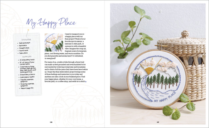 An embroidery book, Sunny Stitches by Schiffer Publishing, Ltd., lies open—left page with instructions, right with a finished landscape hoop beside a basket and plant—ideal inspiration for embroidery projects.