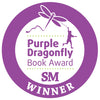 A circular purple badge with a dragonfly and a child holding its string above "Purple Dragonfly Book Award SM Winner," celebrating Max's Box by Schiffer Publishing, Ltd.—a story that nurtures children's emotional growth.
